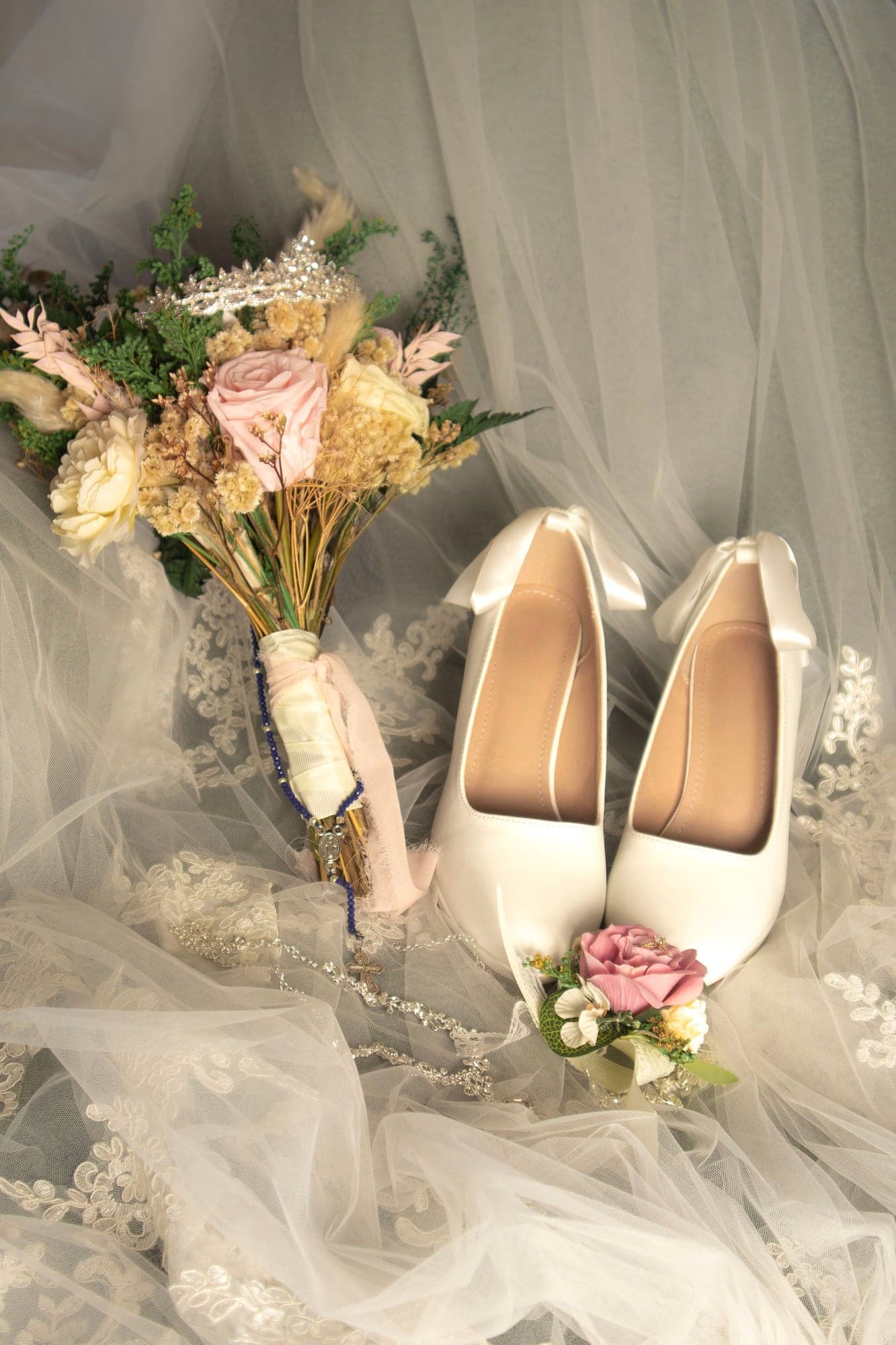 Detalle de los zapatos, el ramo y el velo de la novia